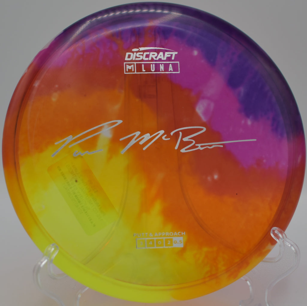 Discraft Fly Dye Z Luna (Paul McBeth) photographed on a wooded fairway at DeLaveaga DGC in Santa Cruz, CA, highlighting its clean release and dependable fade.