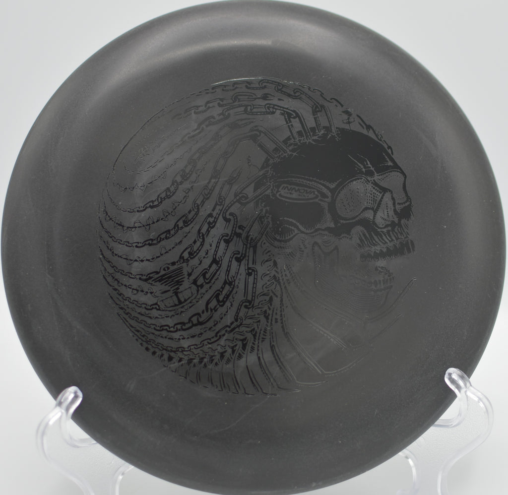 Black DX Aviar sitting on the basket rim after a long-range putt at Mt. Shasta Disc Golf Course in Mt. Shasta, California.