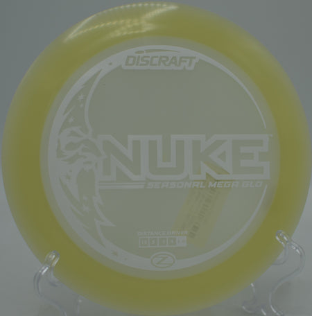 Player crushing a glow-season Nuke flex shot under UV light at Maple Hill Disc Golf Course in Leicester, Massachusetts.