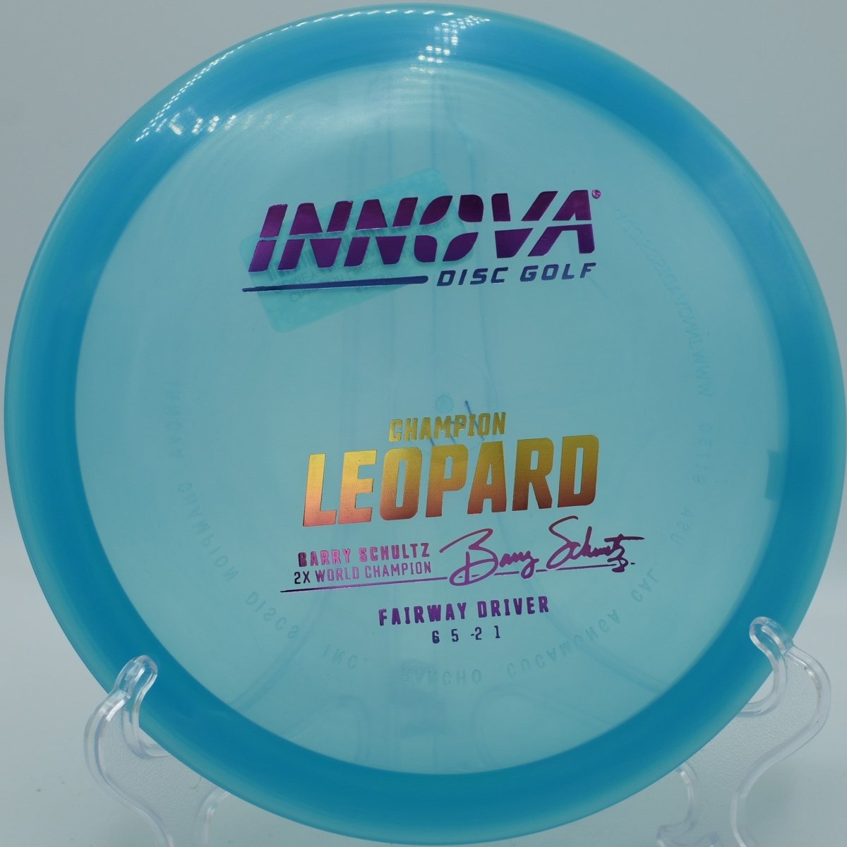 Innova Champion Leopard fairway driver executing a smooth hyzer flip through wooded tunnel at Kensington Metropark Disc Golf Course in Milford, Michigan