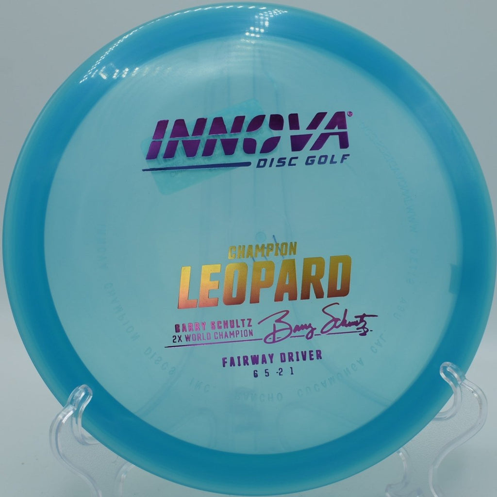 Innova Champion Leopard fairway driver executing a smooth hyzer flip through wooded tunnel at Kensington Metropark Disc Golf Course in Milford, Michigan
