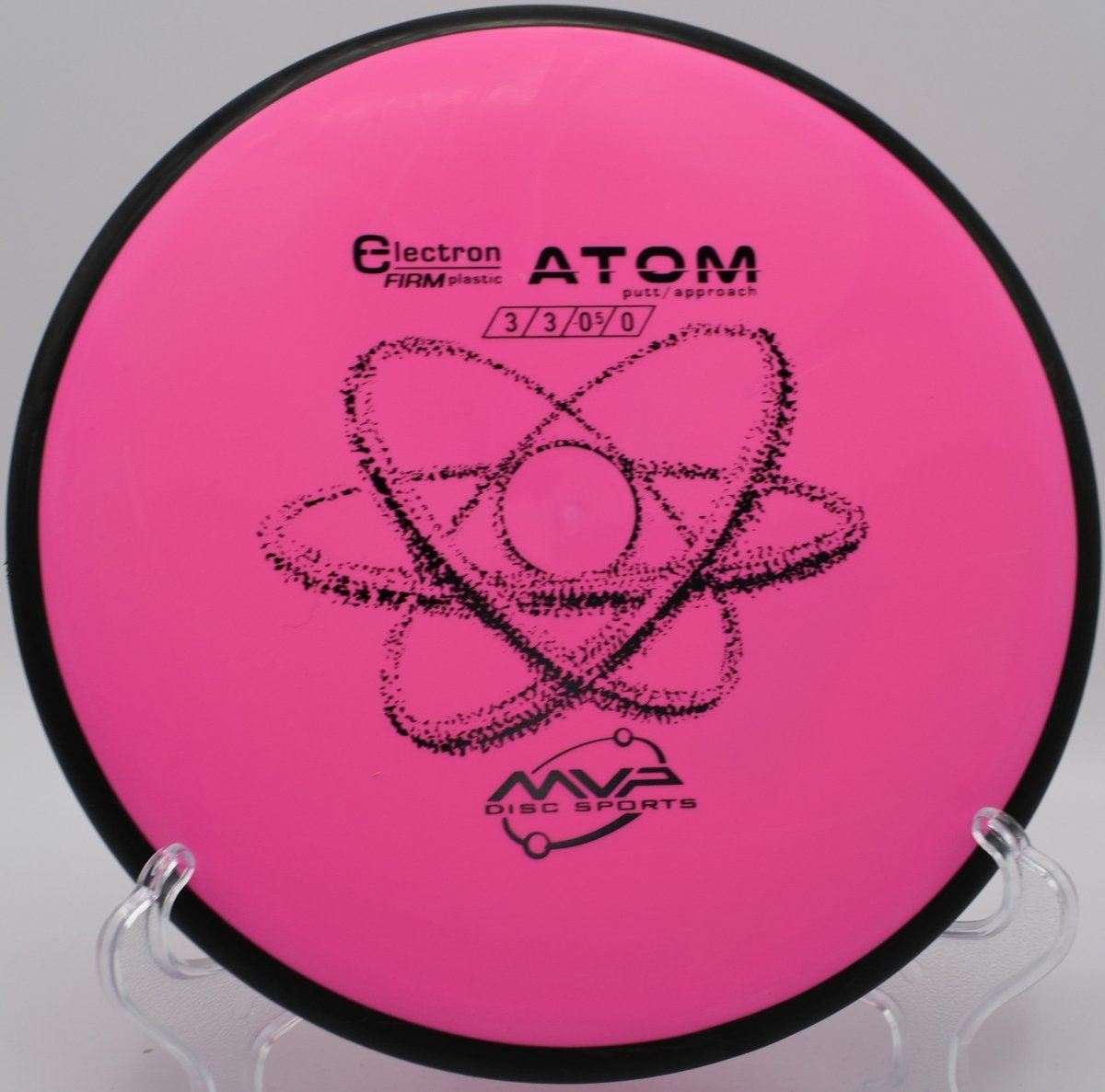 Electron Firm Atom putter lying beside the basket pole after a clean upshot at Devils Den Disc Golf Course in San Marcos, Texas
