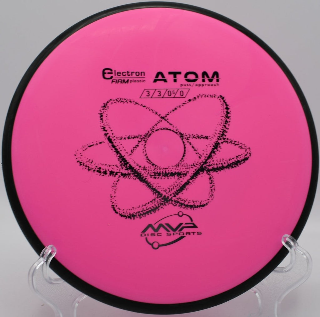 Electron Firm Atom putter lying beside the basket pole after a clean upshot at Devils Den Disc Golf Course in San Marcos, Texas