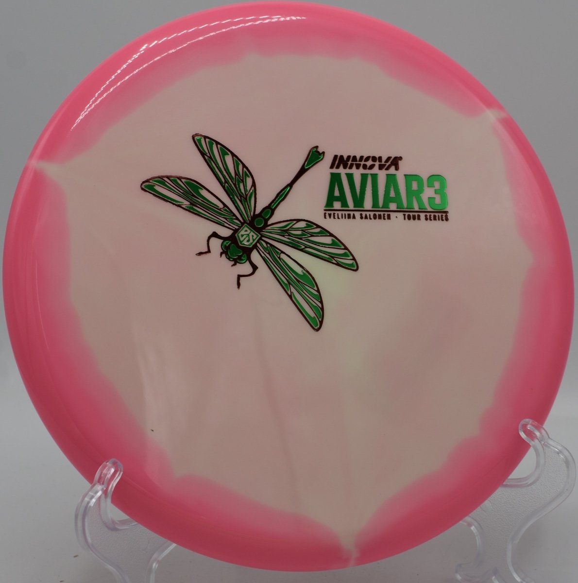 Eveliina Salonen Aviar3 Tour Series putter lying beside the basket pole after a controlled hyzer upshot at Coon Rapids Dam Disc Golf Course in Coon Rapids, Minnesota