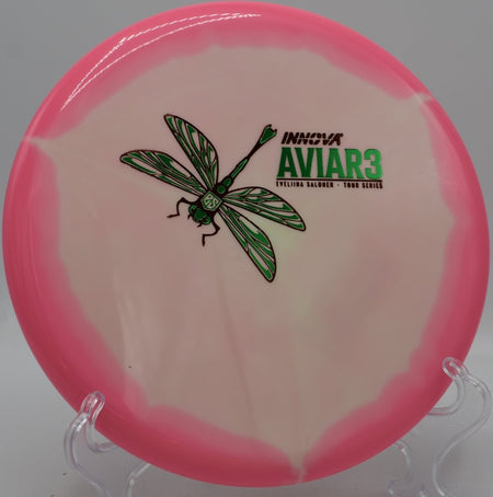 Eveliina Salonen Aviar3 Tour Series putter lying beside the basket pole after a controlled hyzer upshot at Coon Rapids Dam Disc Golf Course in Coon Rapids, Minnesota