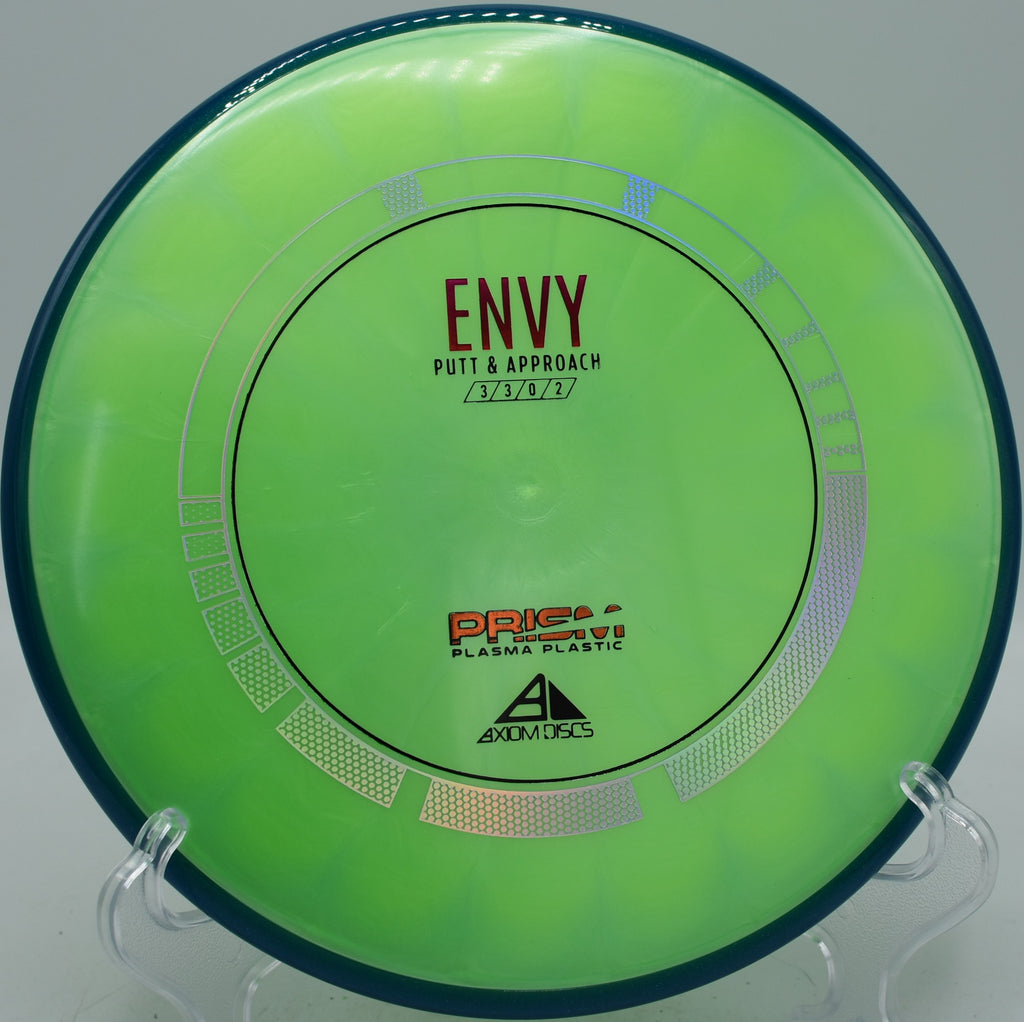 MVP Prism Plasma Envy gliding toward the basket on a wooded tunnel line at Hornets Nest Disc Golf Course in Charlotte, North Carolina.