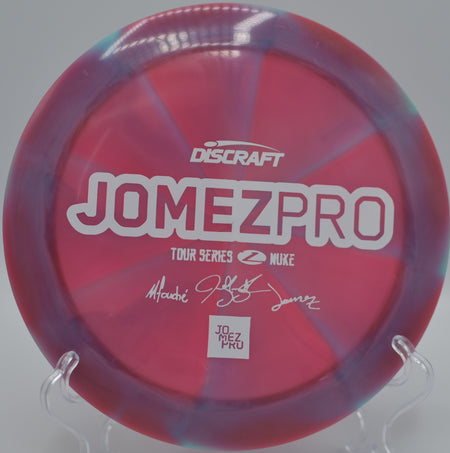 ZomeZPro Z Swirl Nuke ripping through the air at Blue Ribbon Pines Disc Golf Course in East Bethel, Minnesota, capturing its smooth release and elite glide.

