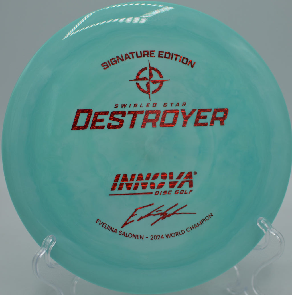 Swirled Star Destroyer by Innova carving a long S-curve line through the trees at Rocklin Disc Golf Course in Rocklin, California.