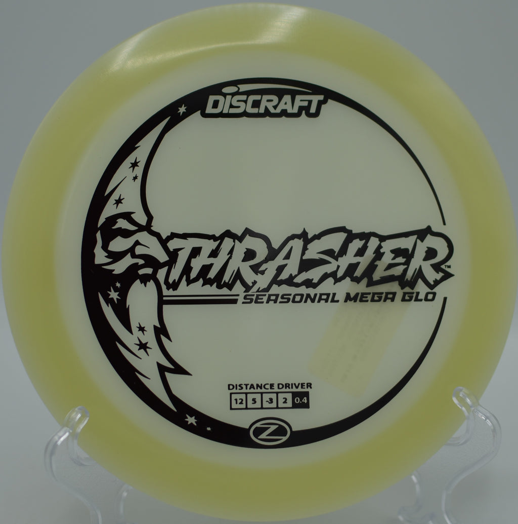 Mega Glow Z Thrasher carving a perfect S-curve under lights at Northwood Black Disc Golf Course in Morton, Illinois.