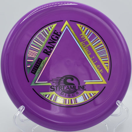 Neutron Soft Range disc golf approach disc resting beside chains after a controlled upshot at Hudson Mills Original Disc Golf Course in Dexter, Michigan