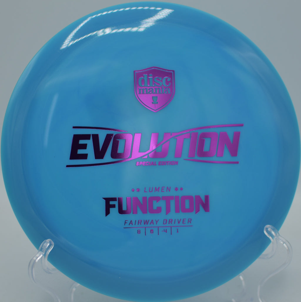 Discmania Neo Lumen Function lightweight fairway driver gliding down wooded tunnels at Northwood Black Disc Golf Course in Morton, Illinois.