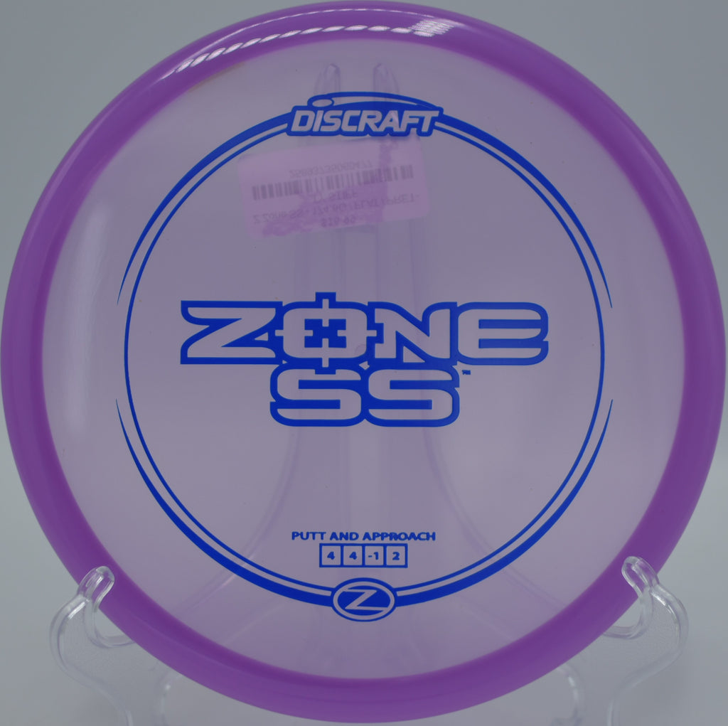 Discraft Z Zone SS spinning toward the chains after a short upshot at Lake Casitas Disc Golf Course in Ventura, California.