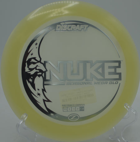 Brightly glowing Discraft Nuke streaking across the fairway during a glow round at Morley Field Disc Golf Course in San Diego, California.