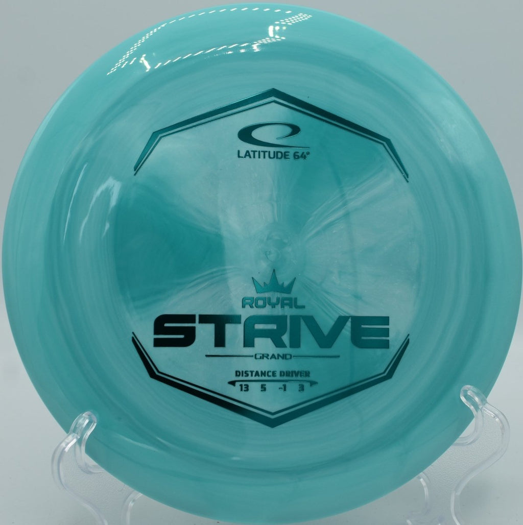 Latitude 64 Grand Strive driver sitting on dirt tee pad at Hornets Nest Disc Golf Course in Charlotte, North Carolina