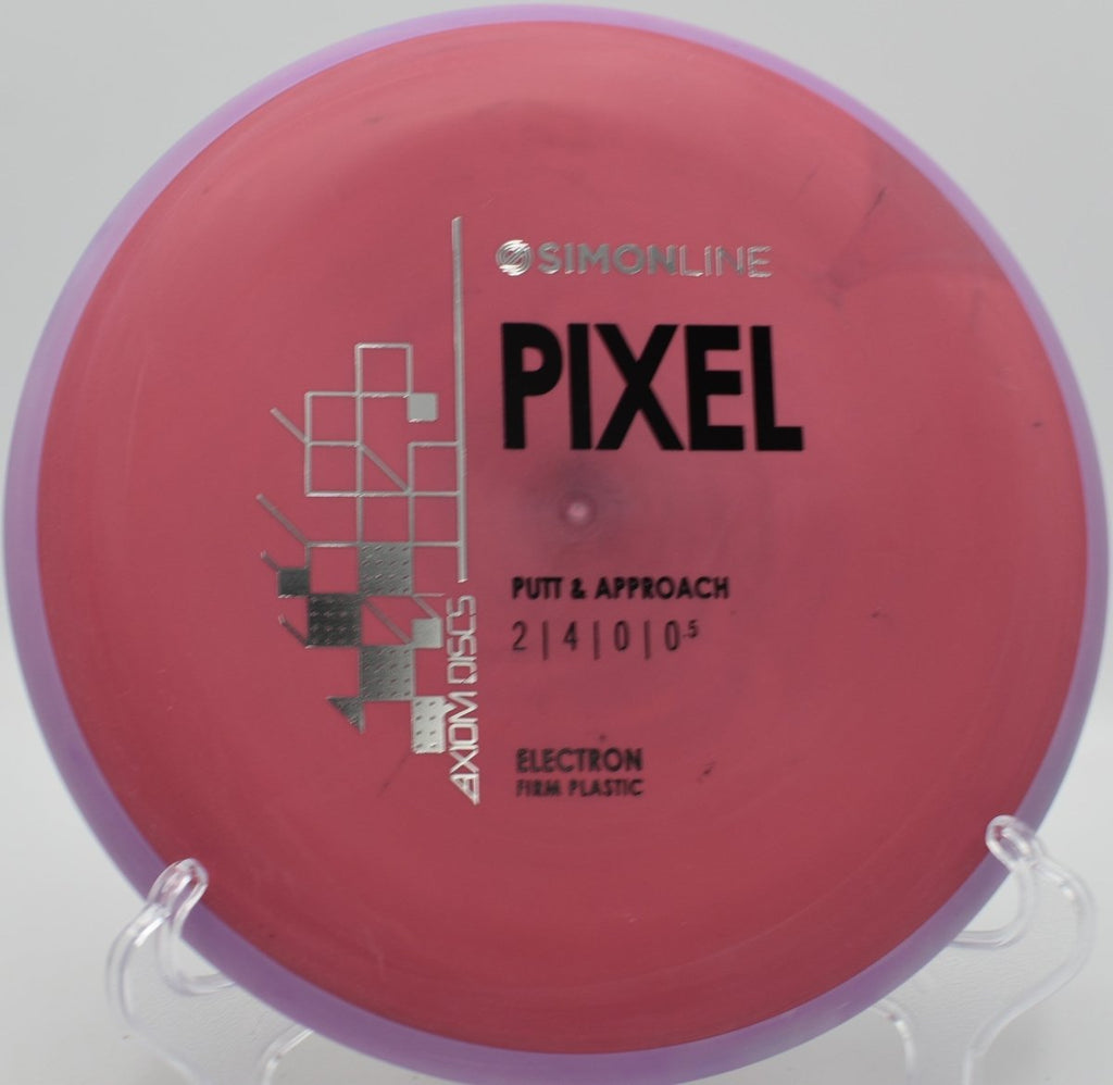 Electron Firm Pixel disc golf putter lying near chains after a smooth approach at Riverfront Park Disc Golf Course in Lawrence, Kansas