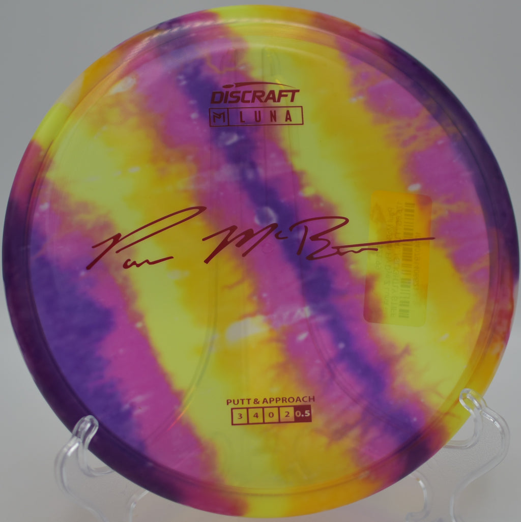 Paul McBeth Z Fly Dye Luna staged on the green at Maple Hill DGC in Leicester, MA, showcasing its stable putt-and-approach performance.