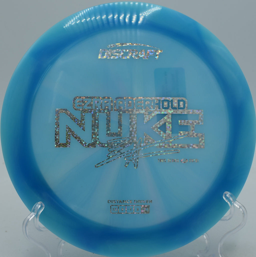 Ezra Aderhold 2025 Z-Swirl Nuke driver unleashing controlled distance on hole 7 at Northwood Black Disc Golf Course in Morton, Illinois.