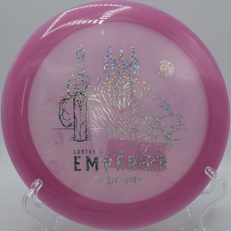 Luster C-Blend Emperor distance driver staged on tee pad for a power drive at Caliber Disc Golf Course in Sandpoint, Idaho