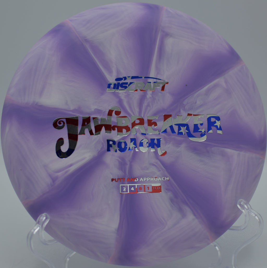 Jawbreaker Roach punching through a wooded lane at Reedy Creek DGC in Charlotte, NC, maintaining stability on a flat, controlled throw.