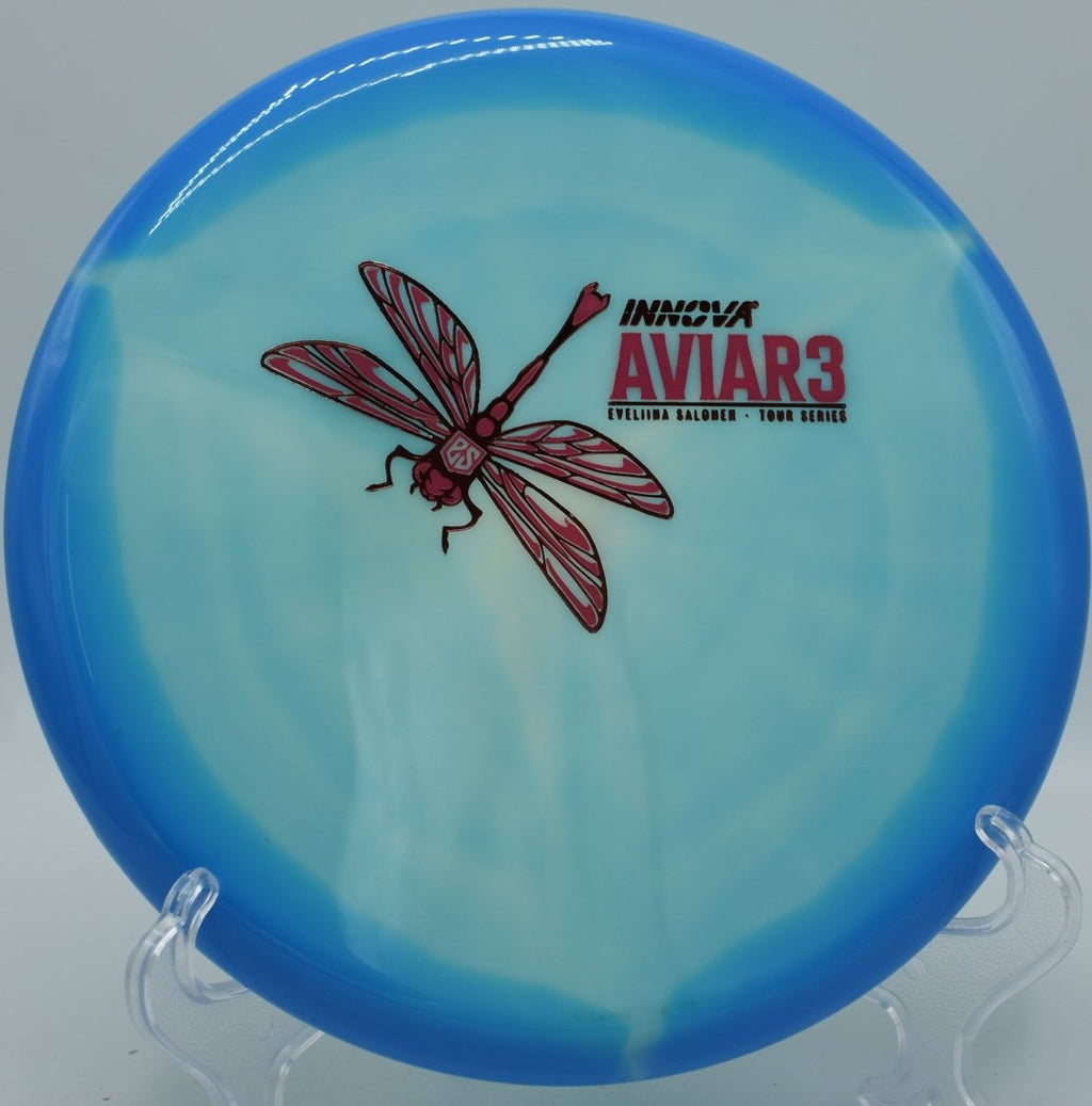 Classic Glow Aviar3 overstable putter resting near chains after a torque-resistant approach at Tom Brown Park Disc Golf Course in Tallahassee, Florida