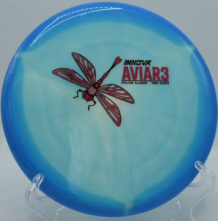 Classic Glow Aviar3 overstable putter resting near chains after a torque-resistant approach at Tom Brown Park Disc Golf Course in Tallahassee, Florida