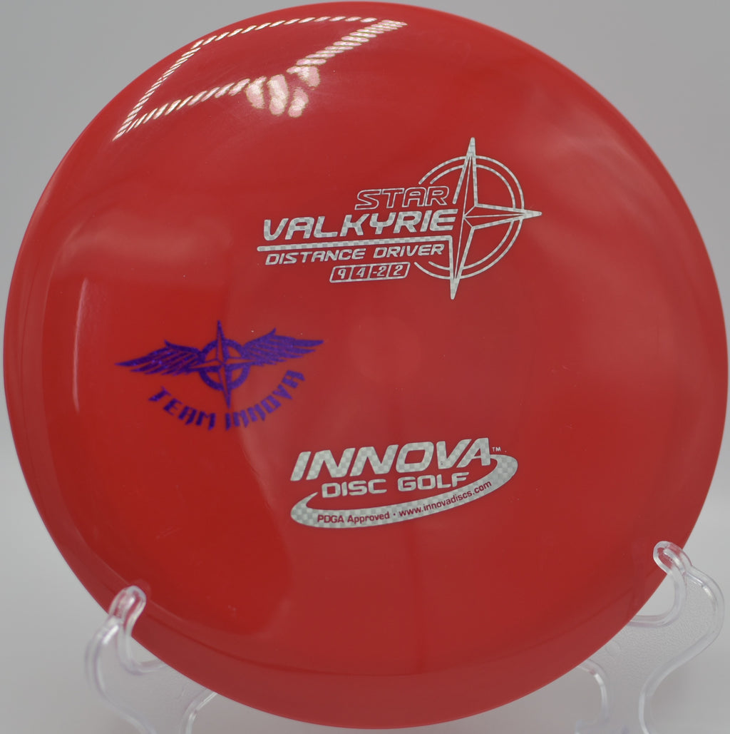 Innova Star Valkyrie (Team Stamp) soaring on a long, controlled turnover drive at DeLaveaga Disc Golf Course in Santa Cruz, California.