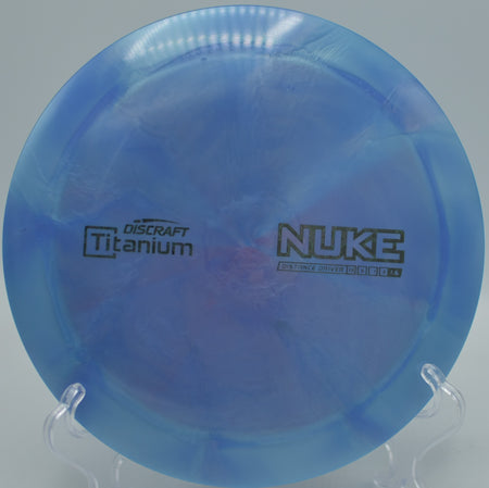 Metallic Titanium Nuke flying flat and far over open fairways at Harmon Hills Disc Golf Course in Fall Branch, Tennessee.