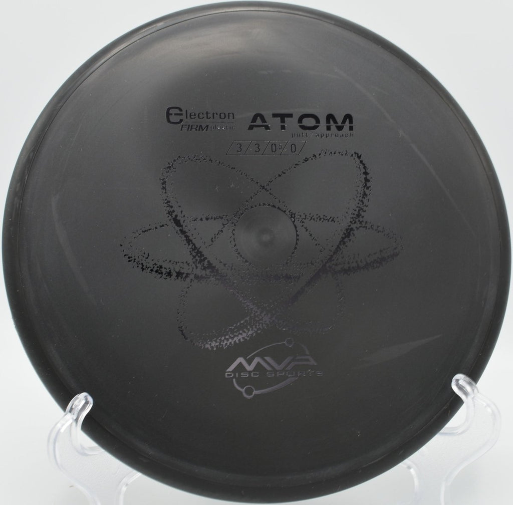 Electron Firm Atom putter resting near chains after a glidey approach at Flaherty Park Disc Golf Course in Wake Forest, North Carolina