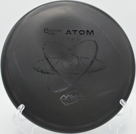 Electron Firm Atom putter resting near chains after a glidey approach at Flaherty Park Disc Golf Course in Wake Forest, North Carolina