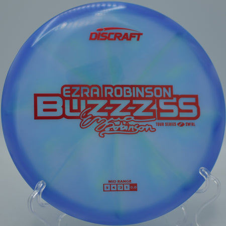 Discraft Ezra Robinson Tour Series Z Swirl Buzzz SS 2025 threading a wooded fairway at Tyler State Park Disc Golf Course in Newtown, Pennsylvania.