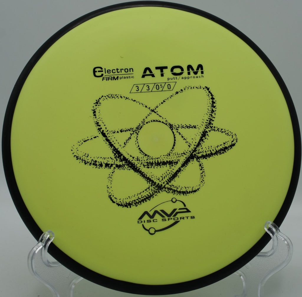 MVP Electron Firm Atom putter parked on the putting surface after a soft landing upshot at Mason County Park Disc Golf Course in Ludington, Michigan