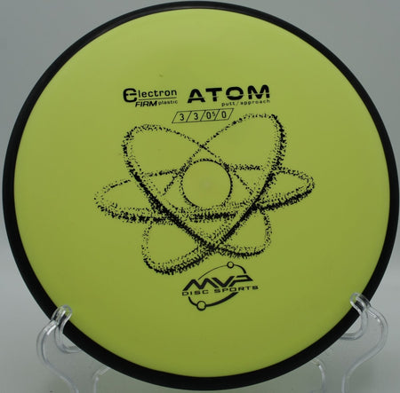 MVP Electron Firm Atom putter parked on the putting surface after a soft landing upshot at Mason County Park Disc Golf Course in Ludington, Michigan