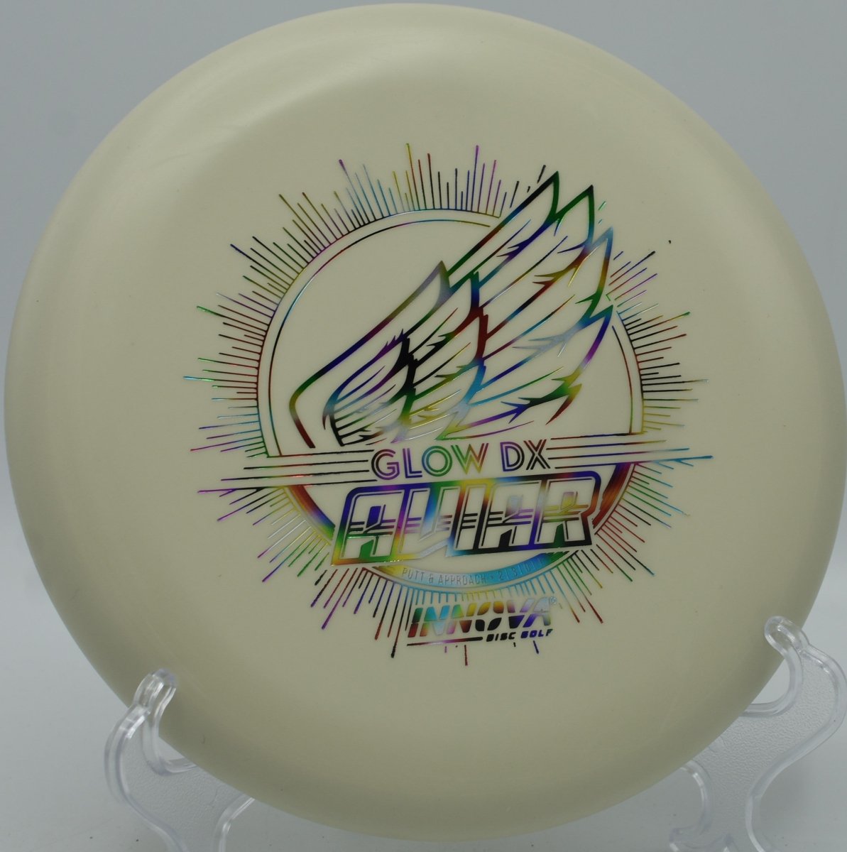 DX Glow Aviar putter resting near chains after a glidey upshot at Riverbend Park Disc Golf Course in Jupiter, Florida