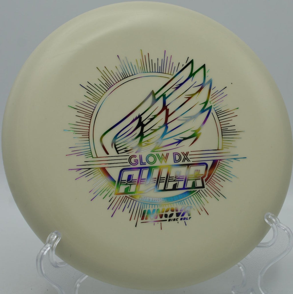 DX Glow Aviar putter resting near chains after a glidey upshot at Riverbend Park Disc Golf Course in Jupiter, Florida