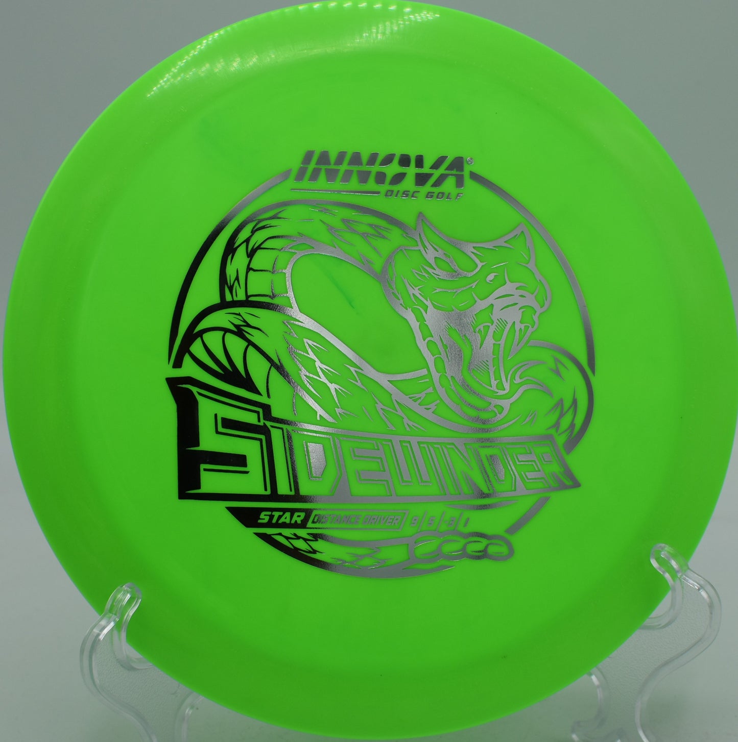 Glowing sunset background with Star Sidewinder mid-flight at Wildcat Bluff Disc Golf Course in Urbana, Iowa