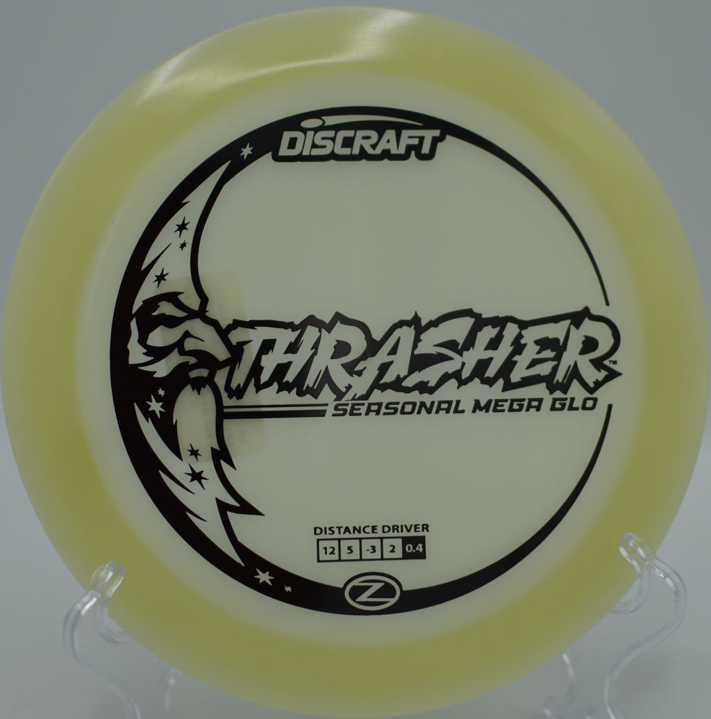 Mega Glow Z Thrasher glowing through desert air on a flex shot at Base Camp Adventure Disc Golf Course in Moab, Utah.