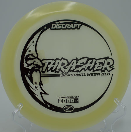 Mega Glow Z Thrasher glowing through desert air on a flex shot at Base Camp Adventure Disc Golf Course in Moab, Utah.