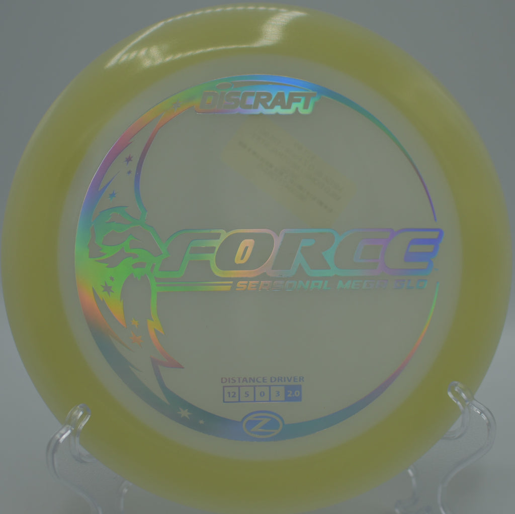 Mega Glow Z Force glowing green as it fades hard left at Eagles Crossing Disc Golf Course in Hawk Point, Missouri.