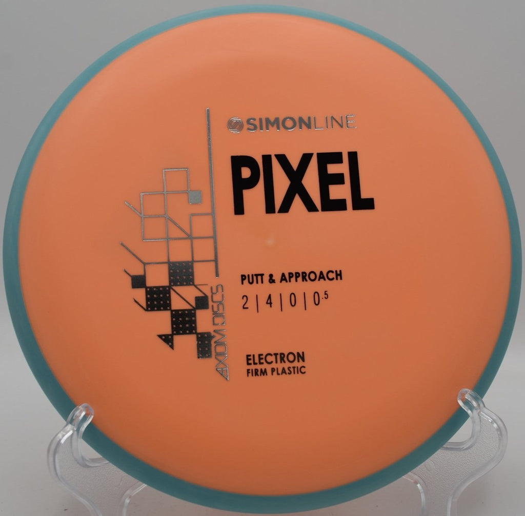 MVP Electron Firm Pixel putter beside the cage after a straight approach shot at Sunset Hills Disc Golf Course in Thousand Oaks, California