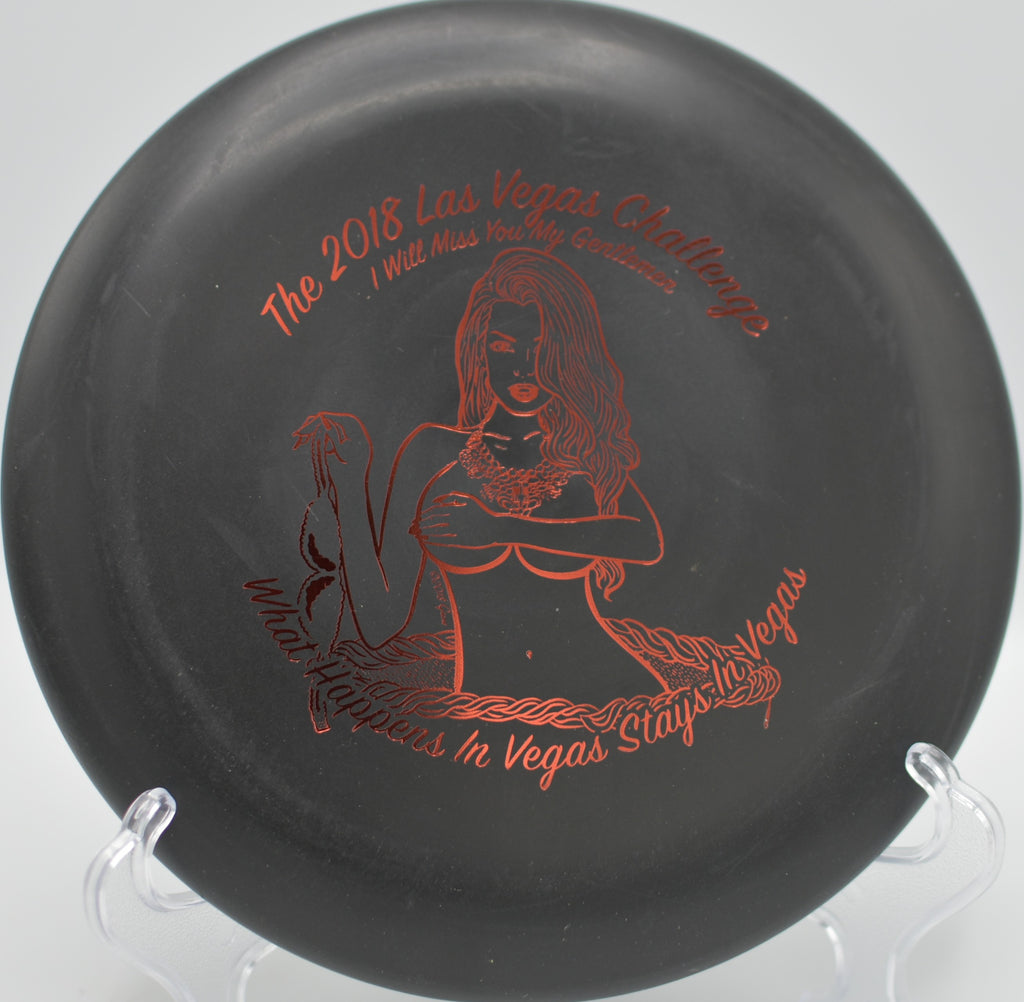 Black DX Aviar gliding down a wooded fairway at Hornets Nest Disc Golf Course in Charlotte, North Carolina.