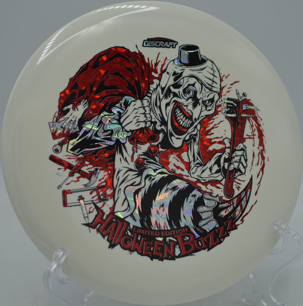 Discraft Halloween 2025 Glo Triple Stamped Buzzz flying flat at Oshtemo Township Park Disc Golf Course in Kalamazoo, Michigan.