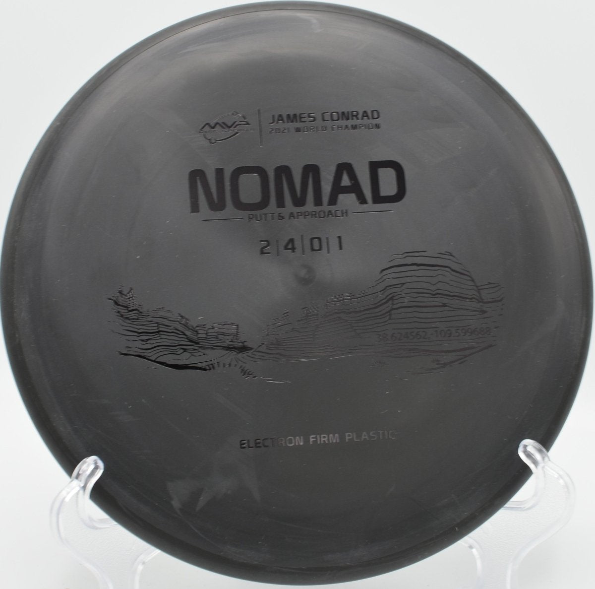 Electron Firm Nomad putter resting near chains after a glidey approach at Bryan Park Disc Golf Course in Greensboro, North Carolina