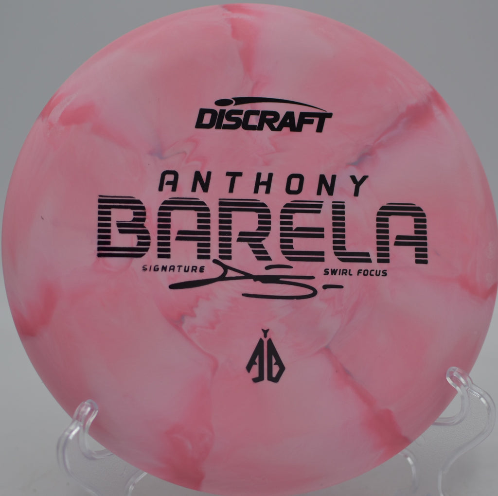 CT Swirl Focus Barela edition glowing stamp parked under the basket at SeaTac Disc Golf Course in SeaTac, Washington.