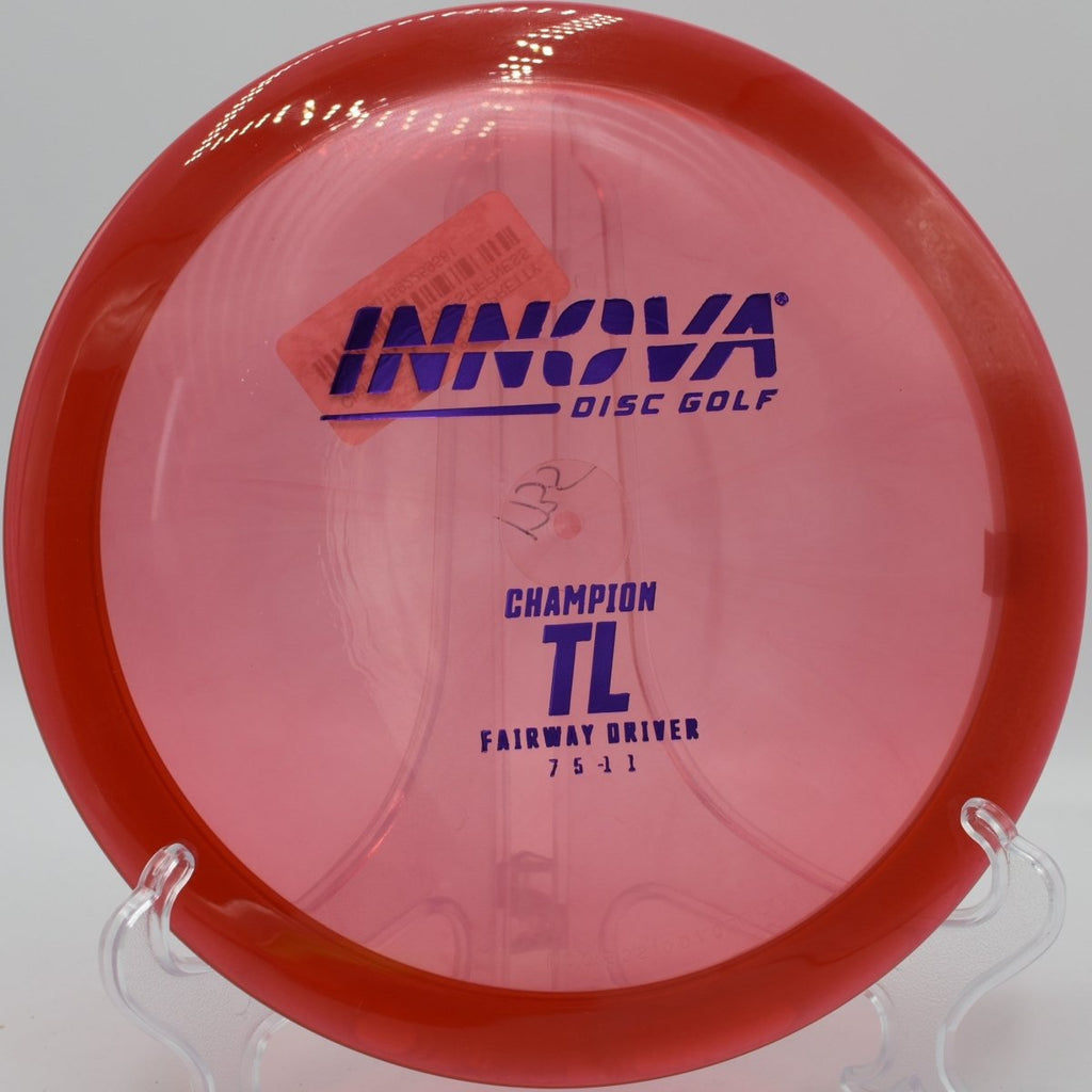 Champion TL fairway driver gliding toward basket chains on a straight control shot at Indian Hills Disc Golf Course in Sioux Falls, South Dakota