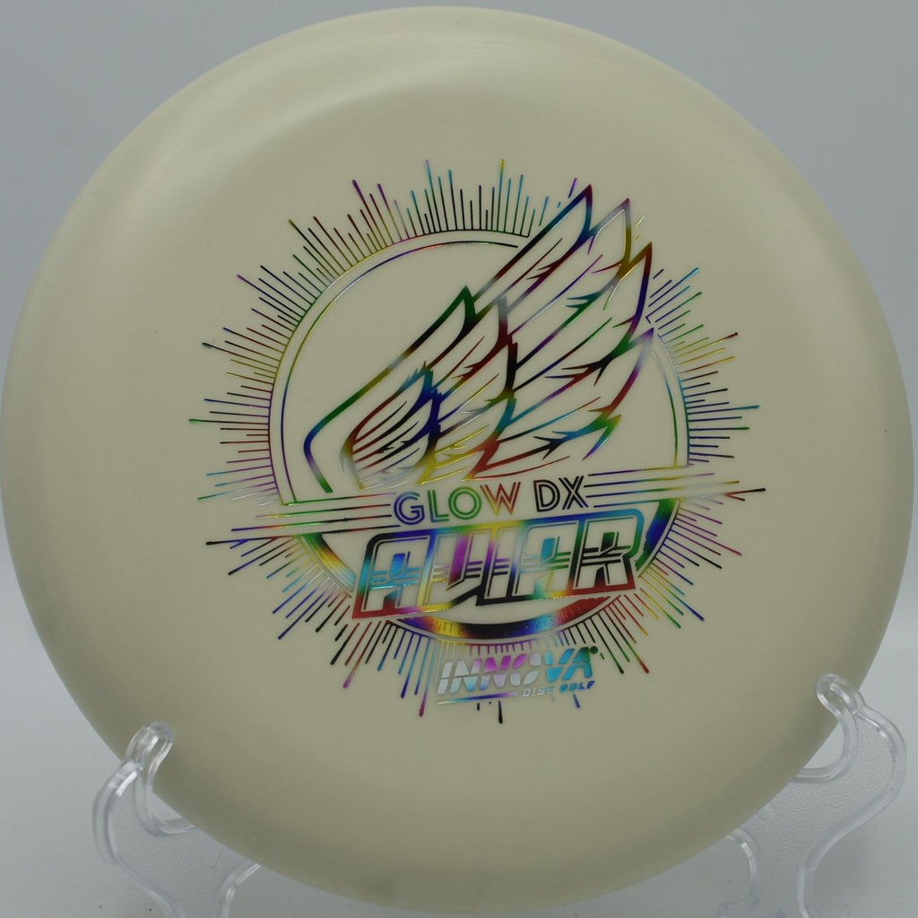 Innova DX Glow Aviar putter glowing on the green after a soft approach at Cadyville Recreation Park Disc Golf Course in Cadyville, New York
