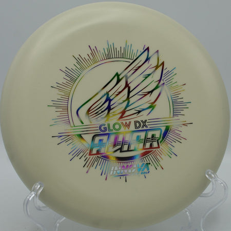 Innova DX Glow Aviar putter glowing on the green after a soft approach at Cadyville Recreation Park Disc Golf Course in Cadyville, New York