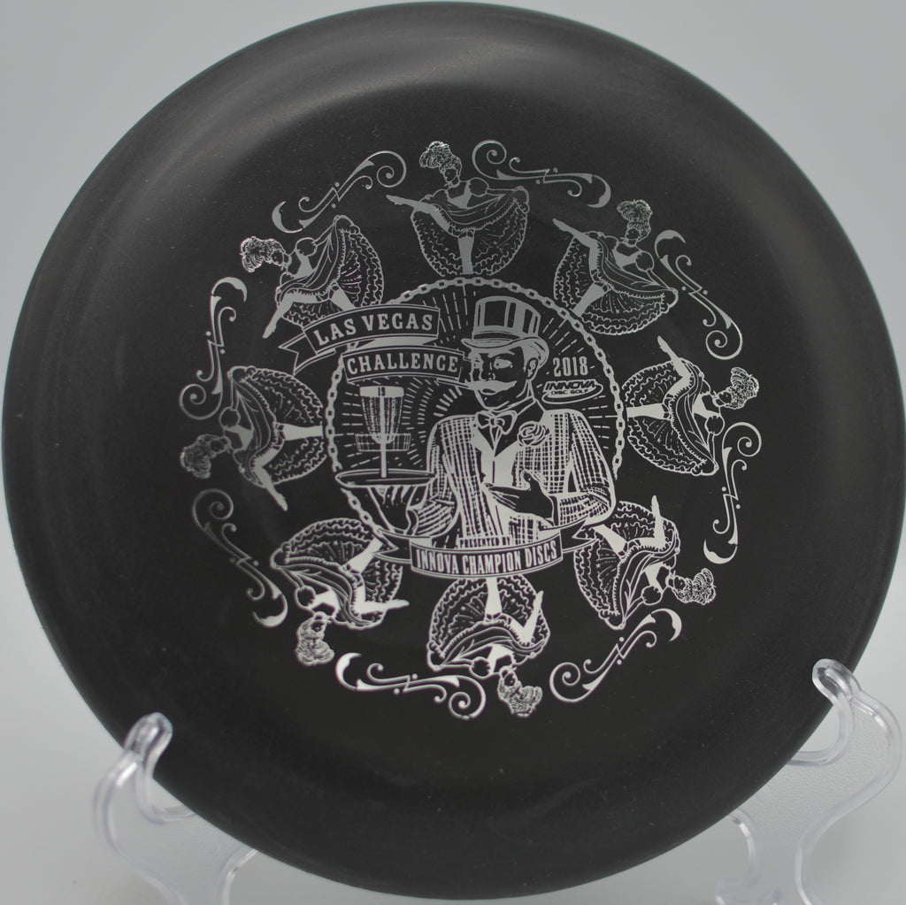 Black DX Aviar resting beside the pole after a clean spin putt at Moraine State Park Disc Golf Course in Portersville, Pennsylvania.