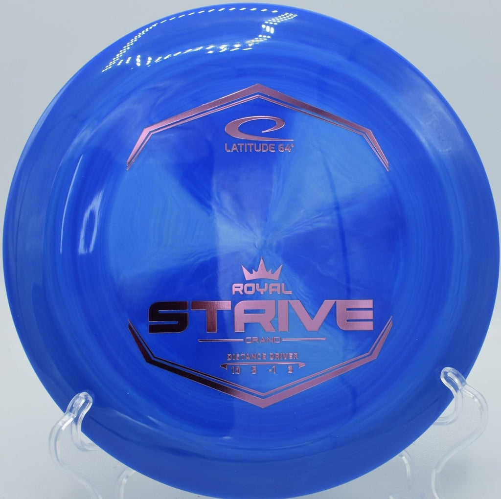 Latitude 64 Grand Strive driver lying in pine needles at Harmon Hills Disc Golf Course in Fall Branch, Tennessee