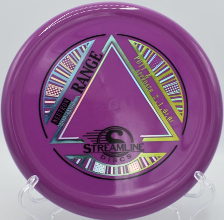 Neutron Soft Range approach disc lying beside the cage after a straight glide upshot at Ridgecrest Park Disc Golf Course in Nacogdoches, Texas