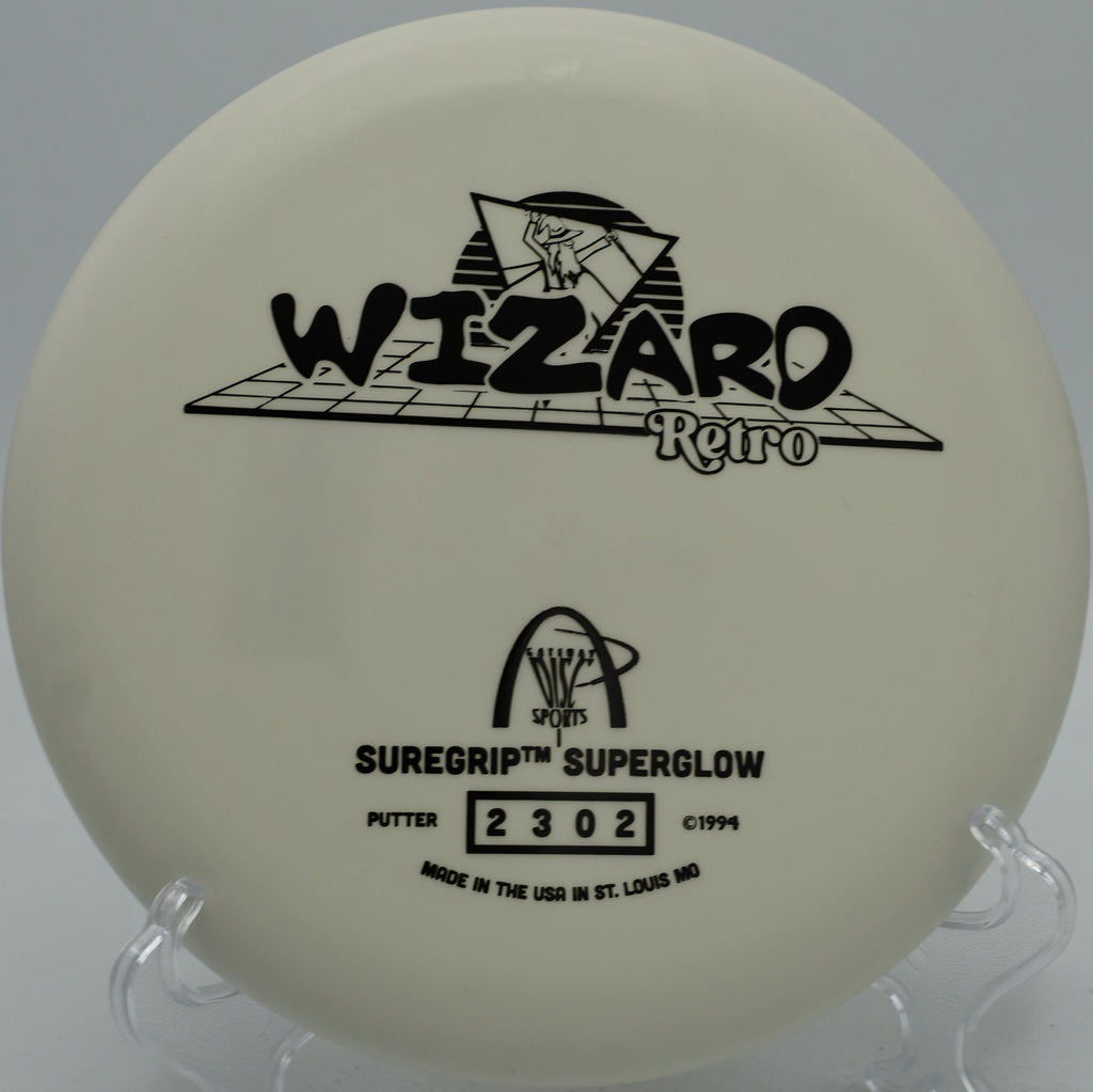 Retro stamp Suregrip Superglow Wizard glowing during a night round at Oregon Park Disc Golf Course in Marietta, GA